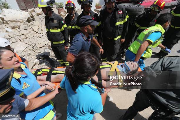 Italian emergency workers evacuate on a stretcher a boy who was was trapped by rubble, in Casamicciola Terme, on the Italian island of Ischia, on...