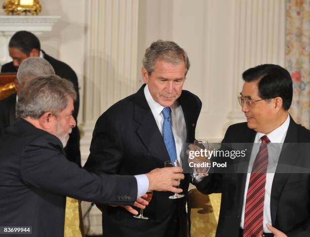 President George W. Bush shares a toast with President Luiz Inacio Lula da Silva of Brazil and President Hu Jinta of China at a summit on financial...