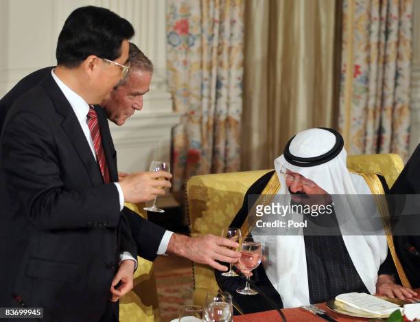 President George W. Bush shares a toast with President Hu Jinta of China and King Abdullah Bin Abdulaziz of Saudi Arabia at a summit on financial...