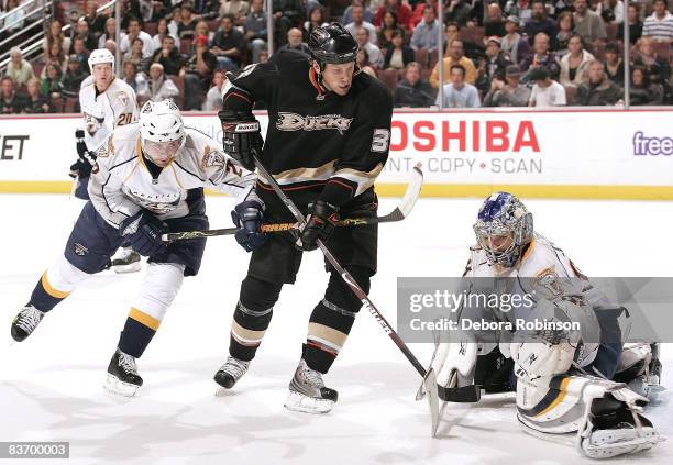 Dan Hamhuis and Dan Ellis of the Nashville Predators defend against Travis Moen of the Anaheim Ducks during the game on November 14, 2008 at Honda...