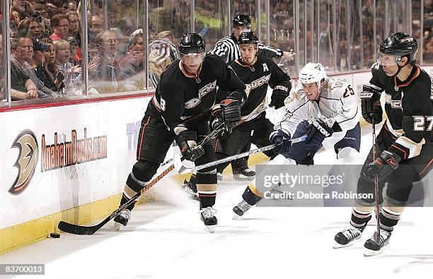 Teemu Selanne, Ryan Getzlaf and Scott Niedermayer of the Anaheim Ducks battle for the puck as against Jerred Smithson of the Nashville Predators...