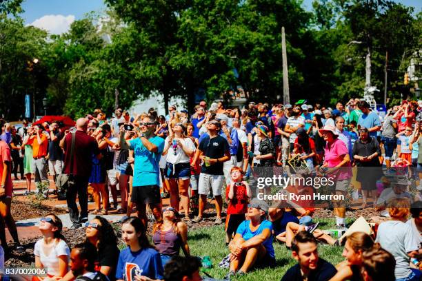 spectators watching the solar eclipse with glasses - solar eclipse glasses stock pictures, royalty-free photos & images