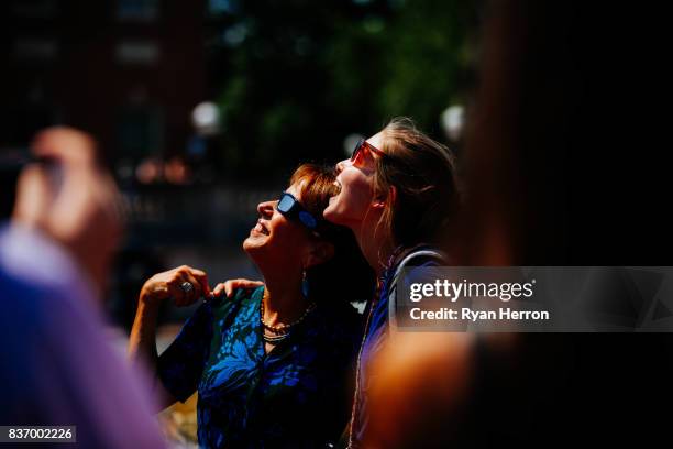 spectators watching the solar eclipse with glasses - eclipse glasses stock pictures, royalty-free photos & images