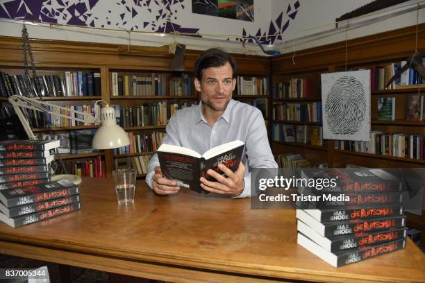 Torben Liebrecht reads a book on set during the RTL Event Movie 'Das Joshua-Profil' Photocall In Berlin on August 22, 2017 in Berlin, Germany.