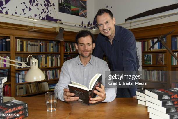 Torben Liebrecht and Sebastian Fitzek read a book on set during the RTL Event Movie 'Das Joshua-Profil' Photocall In Berlin on August 22, 2017 in...