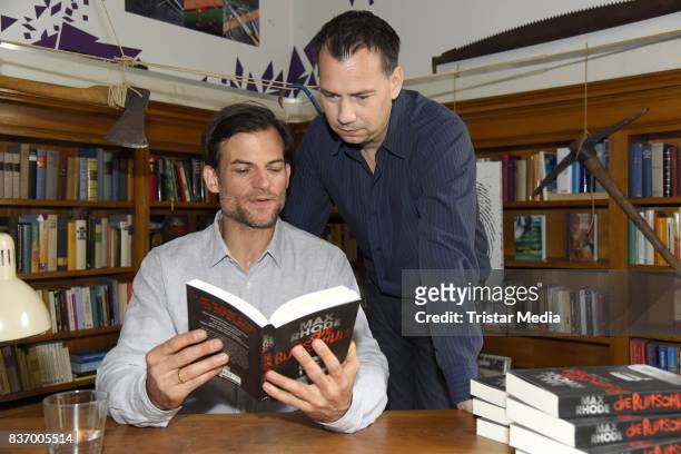 Torben Liebrecht and Sebastian Fitzek read a book on set during the RTL Event Movie 'Das Joshua-Profil' Photocall In Berlin on August 22, 2017 in...