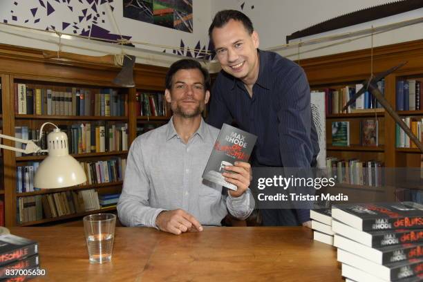 Torben Liebrecht and Sebastian Fitzek read a book on set during the RTL Event Movie 'Das Joshua-Profil' Photocall In Berlin on August 22, 2017 in...