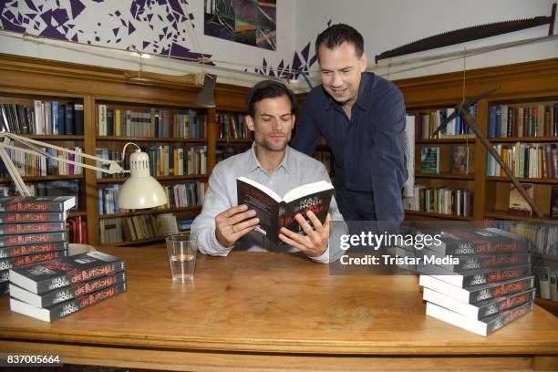 Torben Liebrecht and Sebastian Fitzek read a book on set during the RTL Event Movie 'Das Joshua-Profil' Photocall In Berlin on August 22, 2017 in...