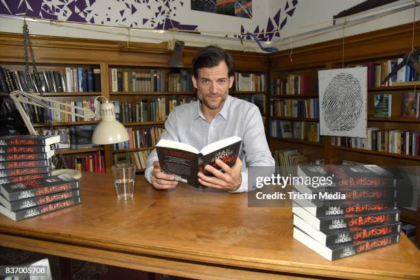 Torben Liebrecht reads a book on set during the RTL Event Movie 'Das Joshua-Profil' Photocall In Berlin on August 22, 2017 in Berlin, Germany.