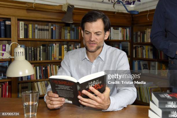 Torben Liebrecht reads a book on set during the RTL Event Movie 'Das Joshua-Profil' Photocall In Berlin on August 22, 2017 in Berlin, Germany.
