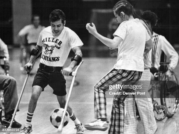 Competition's magic moments Cliff "Clutzy Clifty" Uber of the Fletcher Miller School attempts to dribble ball past Denver Kicker Bobby Howfield, but...