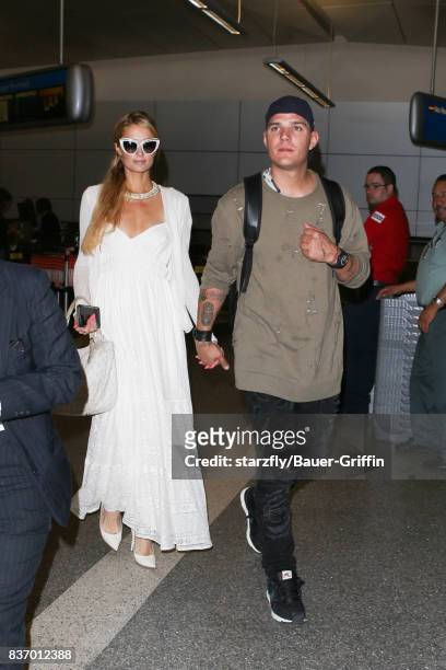 Paris Hilton and Chris Zylka are seen at LAX on August 21, 2017 in Los Angeles, California.