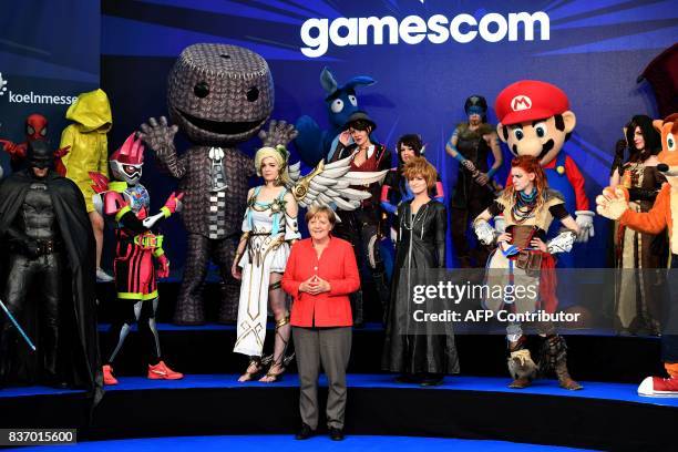 German Chancellor Angela Merkel attends the gaming fair "gamescom" during the opening ceremony in Cologne on August 22, 2017. / AFP PHOTO / PATRIK...