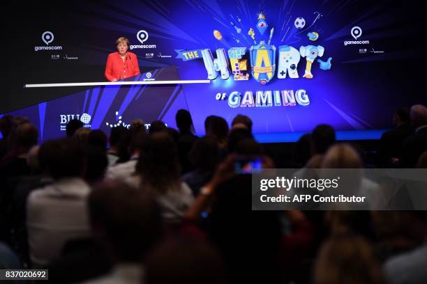German Chancellor Angela Merkel attends the gaming fair "gamescom" during the opening ceremony in Cologne on August 22, 2017. / AFP PHOTO / PATRIK...