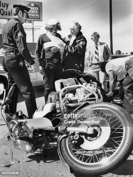 Patrolman Injured Avoiding Accident Motorcycle Patrolman Dave Duncan is tended after being injured Monday afternoon at West Colfax Avenue and Zuni...