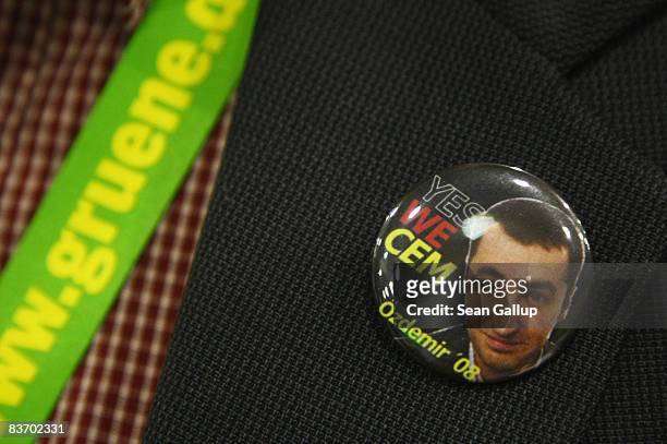 Delegate wears a button in support of Cem Oezdemir, German Greens Party European Parliament deputy, as new party chairman at the Greens Party annual...