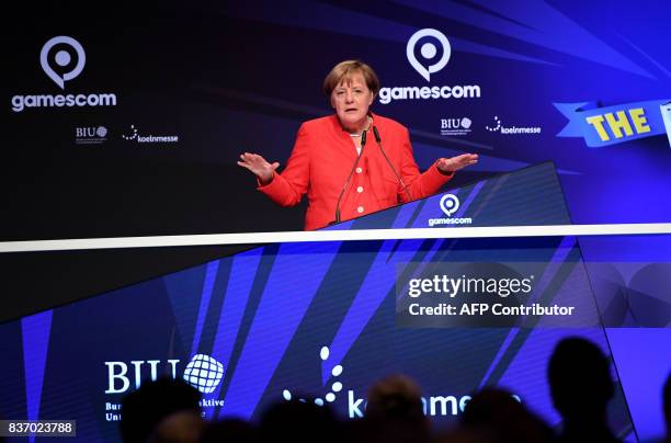 German Chancellor Angela Merkel holds the opening speech during the opening ceremony of the gaming fair "gamescom" in Cologne on August 22, 2017. /...
