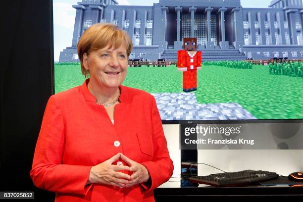 German Chancellor Angela Merkel visits the Microsoft stand during a tour through the gamescom halls at the Gamescom 2017 gaming trade fair during the...