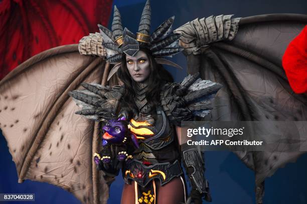 Person dressed up as game character is seen during the opening ceremony of gaming fair "gamescom" in Cologne on August 22, 2017. / AFP PHOTO / PATRIK...