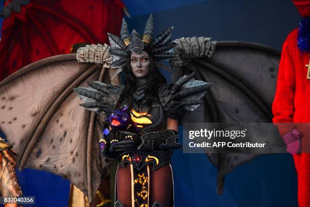 Person dressed up as game character is seen during the opening ceremony of gaming fair "gamescom" in Cologne on August 22, 2017. / AFP PHOTO / PATRIK...