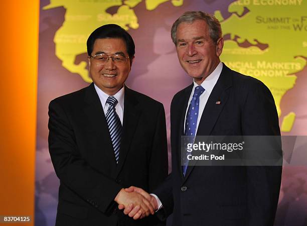 President George W. Bush poses with the President of China Hu Jintao during the Summit on Financial Markets and the World Economy at the National...