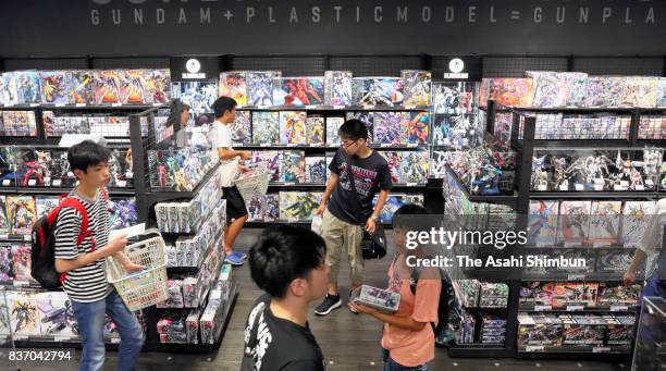 Shoppers at Gundam Base Tokyo check at Gundam Base Tokyo on August 19, 2017 in Tokyo, Japan. Gundam mania swooped into the capital on Aug. 19 with a...