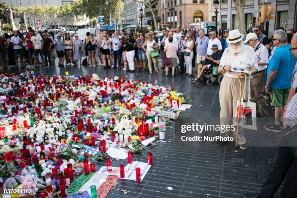 People display flowers, candles, balloons and many objects to pay tribute to the victims of the Barcelona and Cambrils attacks on the Rambla...