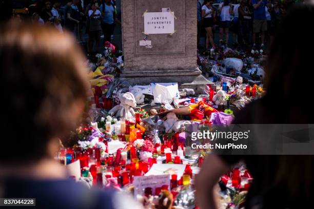 People display flowers, candles, balloons and many objects to pay tribute to the victims of the Barcelona and Cambrils attacks on the Rambla...