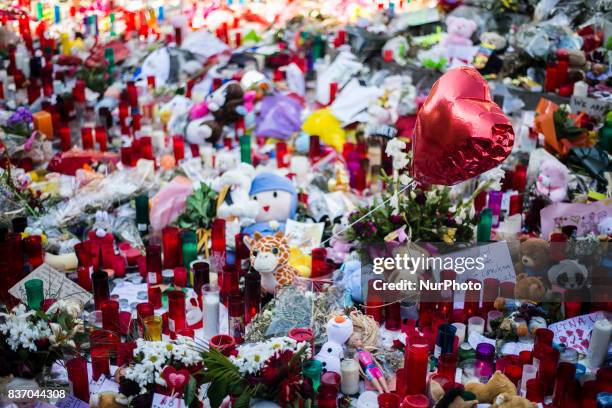 People display flowers, candles, balloons and many objects to pay tribute to the victims of the Barcelona and Cambrils attacks on the Rambla...