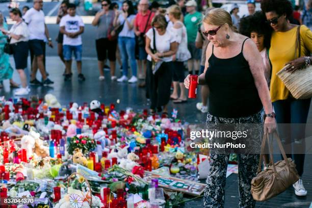 People display flowers, candles, balloons and many objects to pay tribute to the victims of the Barcelona and Cambrils attacks on the Rambla...