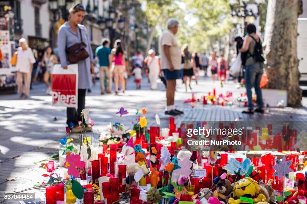 People display flowers, candles, balloons and many objects to pay tribute to the victims of the Barcelona and Cambrils attacks on the Rambla...