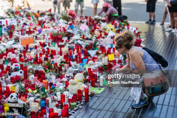 People display flowers, candles, balloons and many objects to pay tribute to the victims of the Barcelona and Cambrils attacks on the Rambla...