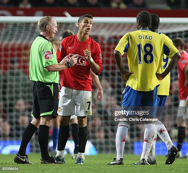 Cristiano Ronaldo of Manchester United clashes with Salif Diao of Stoke City during the Barclays Premier League match between Manchester United and...