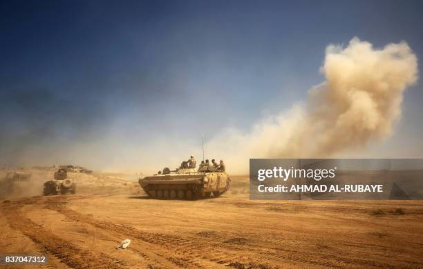 Iraqi forces backed by the Hashed Al-Shaabi advance towards the town of Tal Afar, west of Mosul, after the Iraqi government announced the beginning...