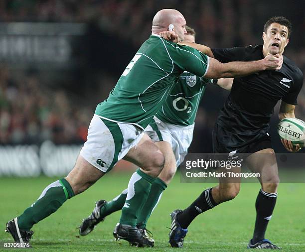 John Hayes of Ireland tackles Dan Carter of New Zealand during the Guinness series match between Ireland and New Zealand at Croke Park on November...