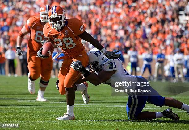 Spiller of the Clemson Tigers works to shake off Vincent Rey of the Duke Blue Devils at Memorial Stadium on November 15, 2008 in Clemson, South...