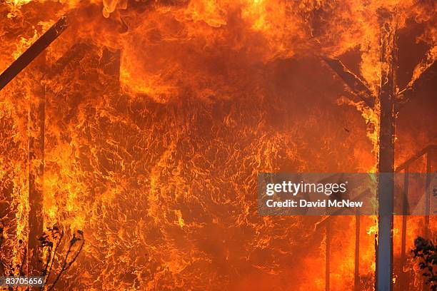 Large flames are blown from a burning mobile homes by strong wind as most of the homes in the Oakridge mobile home park, which reportedly has 600-800...