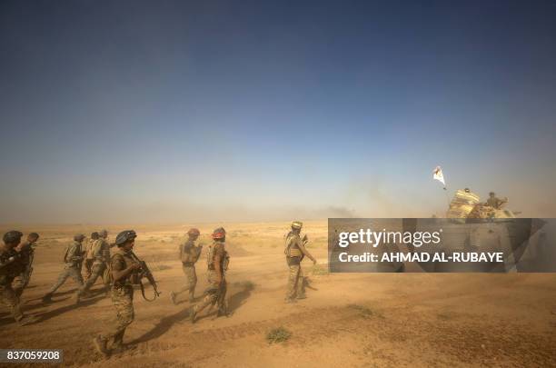 Fighters of the Hashed Al-Shaabi advance towards the town of Tal Afar, west of Mosul, after the Iraqi government announced the beginning of the...