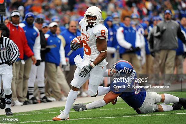 Quan Cosby of the Texas Longhorns runs past Joe Mortensen of the Kansas Jayhawks on November 15, 2008 at Memorial Stadium in Lawrence, Kansas. Texas...