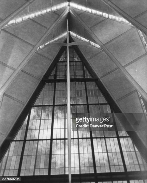 Above the Holy Table in the Protestant chapel floats a 46-foot aluminum cross. The north wall is of laminated architectural glass forming backdrop...