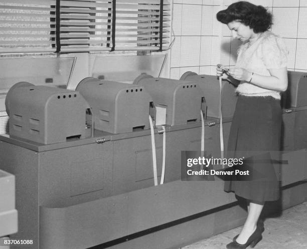 Loretta Vaughn, 1540 Washington Sheet an Operator Inspecting a message coming into the Machines. Credit: Denver Post