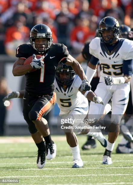 Jacquizz Rodgers of the Oregon State Beavers runs with the ball against Syd'Quan Thompson of the California Golden Bears at Reser Stadium on November...