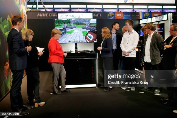 German Chancellor Angela Merkel visits the Microsoft stand with Thomas Kowollik, Shannon Loftis, a high-school graduate, Mirek Hancl, Armin Laschet,...