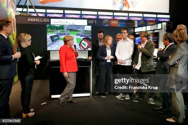 German Chancellor Angela Merkel visits the Microsoft stand with Thomas Kowollik, Shannon Loftis, a high-school graduate, Mirek Hancl, Armin Laschet,...