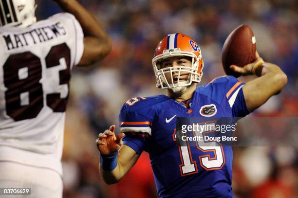 Quarterback Tim Tebow of the Florida Gators throws a touchdown pass in the fourth quarter over defensive end Cliff Matthews of the South Carolina...