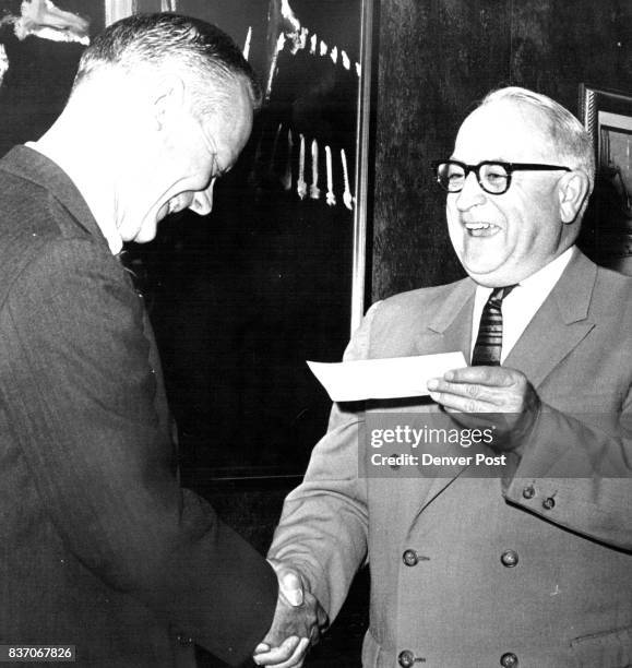 Aids CU Students Dr. John J. Conger, left, dean of the University of Colorado Medical School, accepts check for $16,178 from Dr. Myron C. Waddell,...