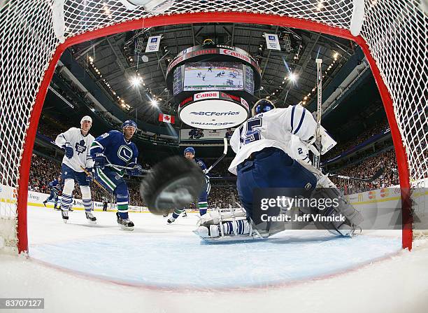 Pavol Demitra of the Vancouver Canucks watches on as teammate Daniel Sedin scores a goal on Vesa Toskala of the Toronto Maple Leafs during their game...