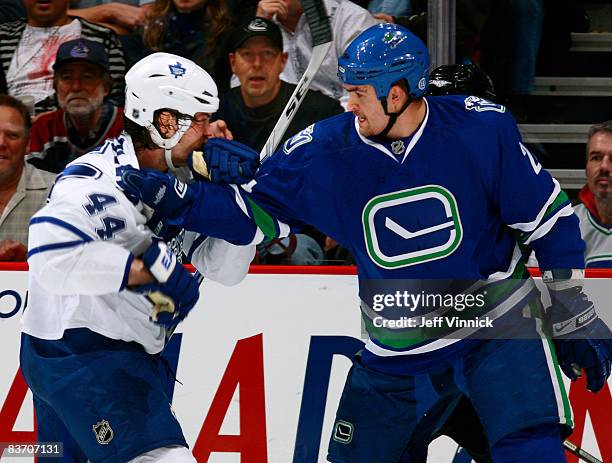 Darcy Hordichuk of the Vancouver Canucks gets ready to fight Ryan Hollweg of the Toronto Maple Leafs during their game against the Toronto Maple...