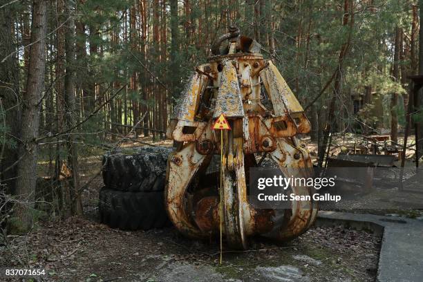 Highly-radioactive, contaminated metal claw, likely used in the post-accident clean-up, stands on the ground in a forest on the outskirts of the...
