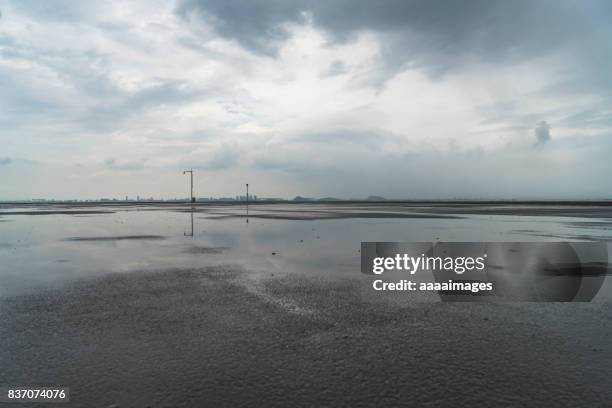 close to tarmac ground against cloudy sky - wet road stock pictures, royalty-free photos & images